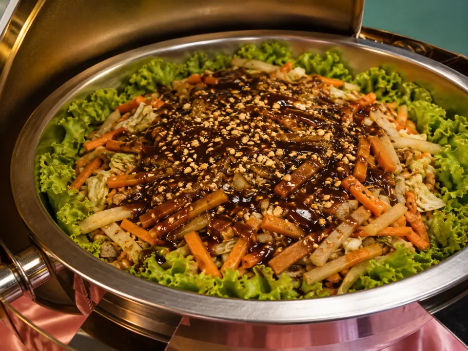 Lumpiang hubad with vegetables and sweet sauce in a chafing dish