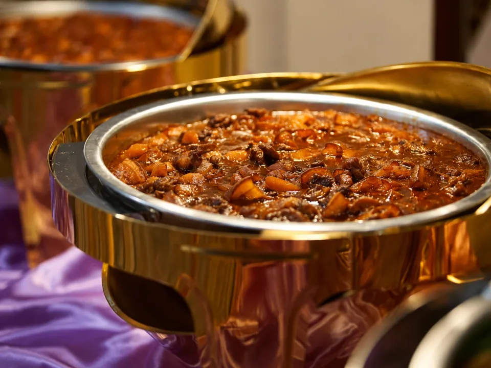 Pork caldereta with potatoes, carrots, and bell peppers in a chafing dish
